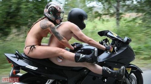 Woman riding motorcycle nude