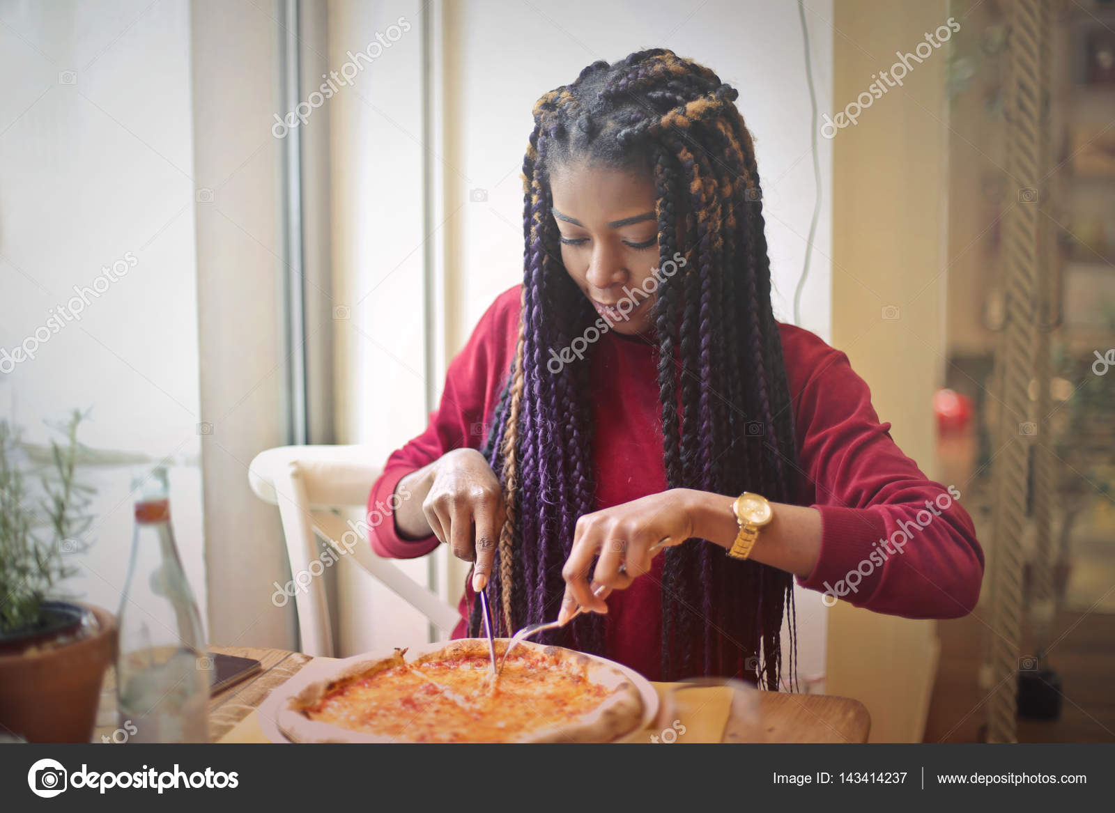 Black girl eating pizza