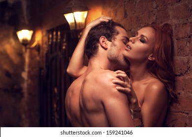 Beautiful naked women kissing man